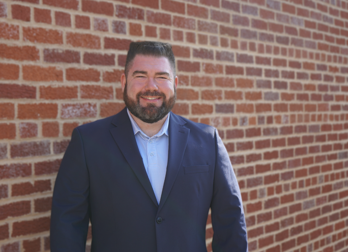 Headshot of Nick Townsend in front of brick wall